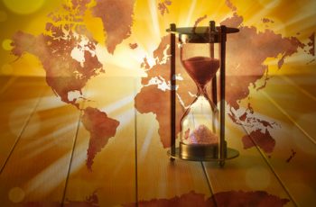 A conceptual image with an hourglass with a world map